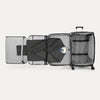 Open suitcase with suit displayed in fold out suiter compartment on white background