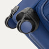 Close-up of Travelpro Versapack Spinner in Estate Blue, featuring color-matched 360° Spinner Wheels for smooth mobility.