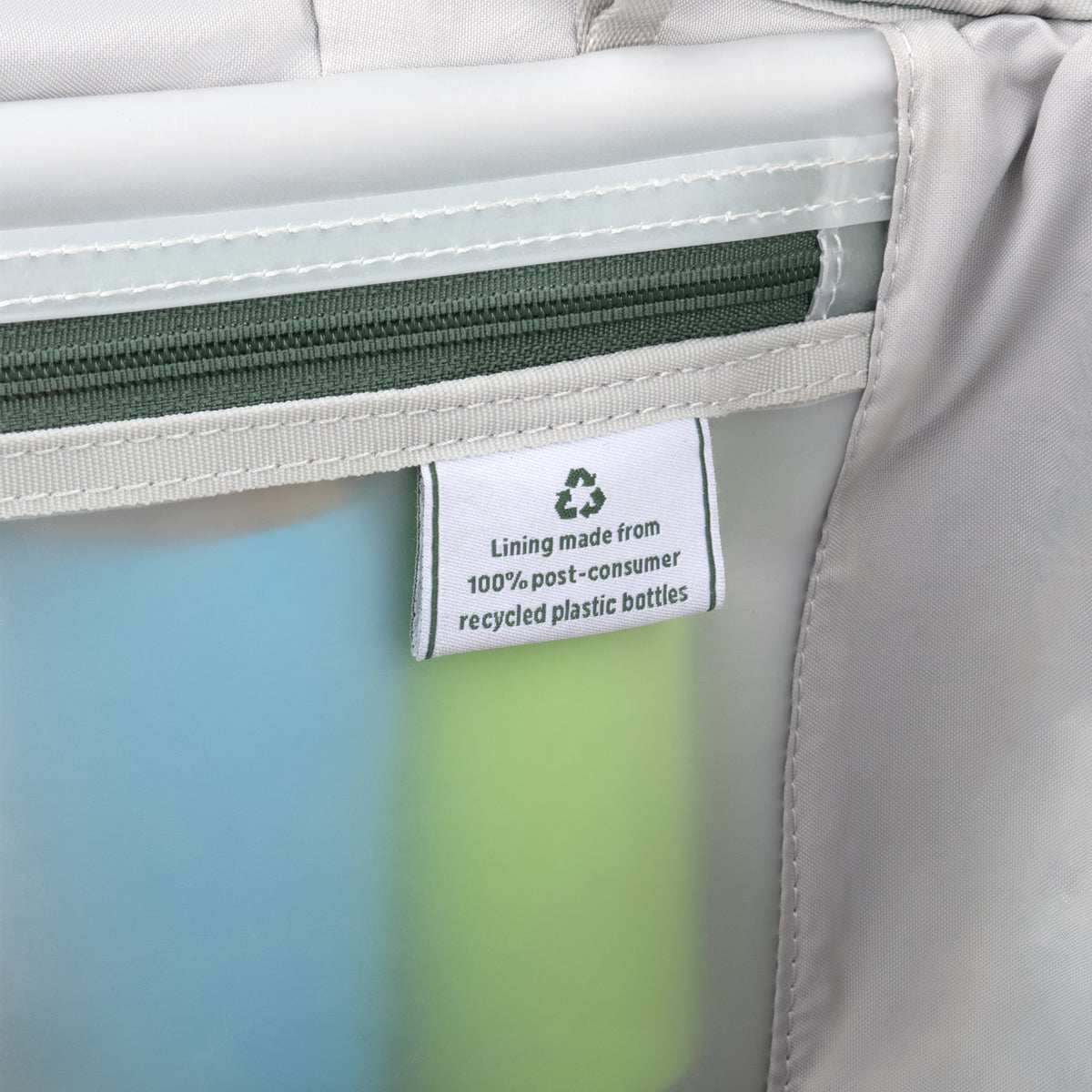 Interior lining tag on a Travelpro suitcase, highlighting construction from 100% post-consumer recycled plastic bottles.