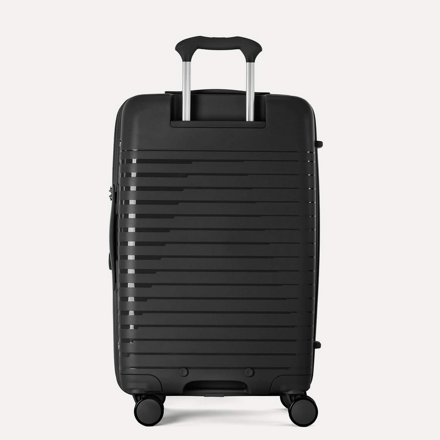 Valise noire à texture nervurée sur fond gris clair