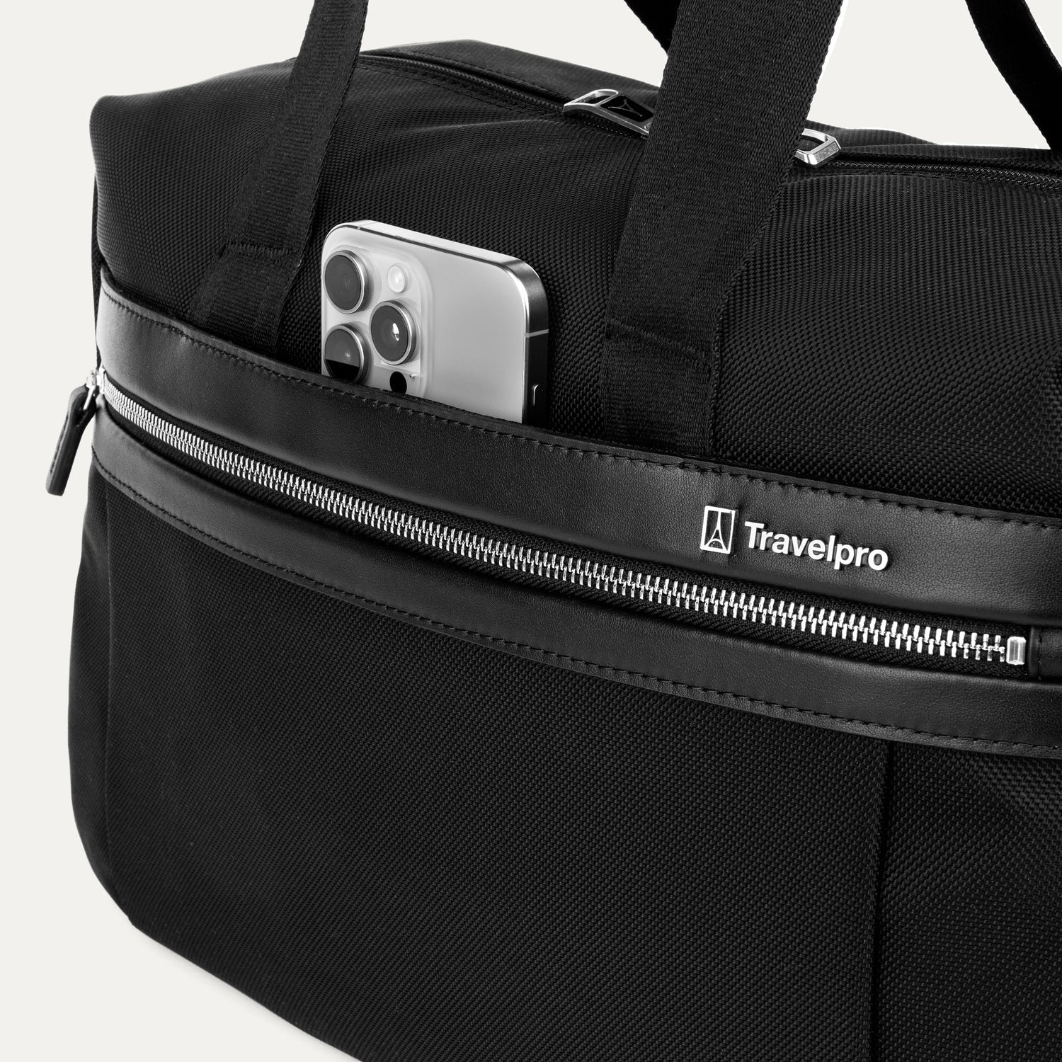 Black tote with a phone in the QuickSlip® front pocket compartment on a white background