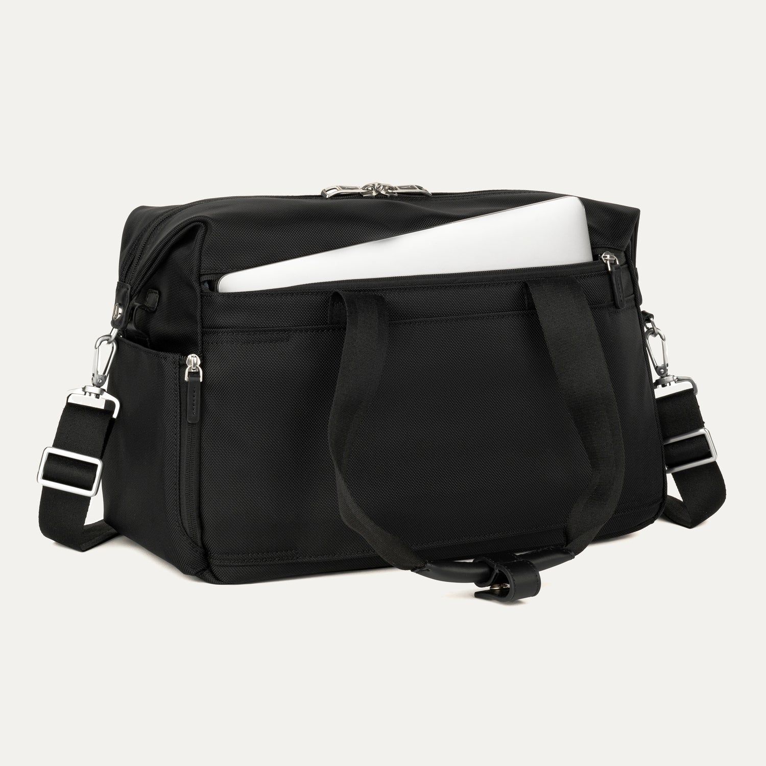 Black tote with a laptop in the padded sleeve compartment on a white background