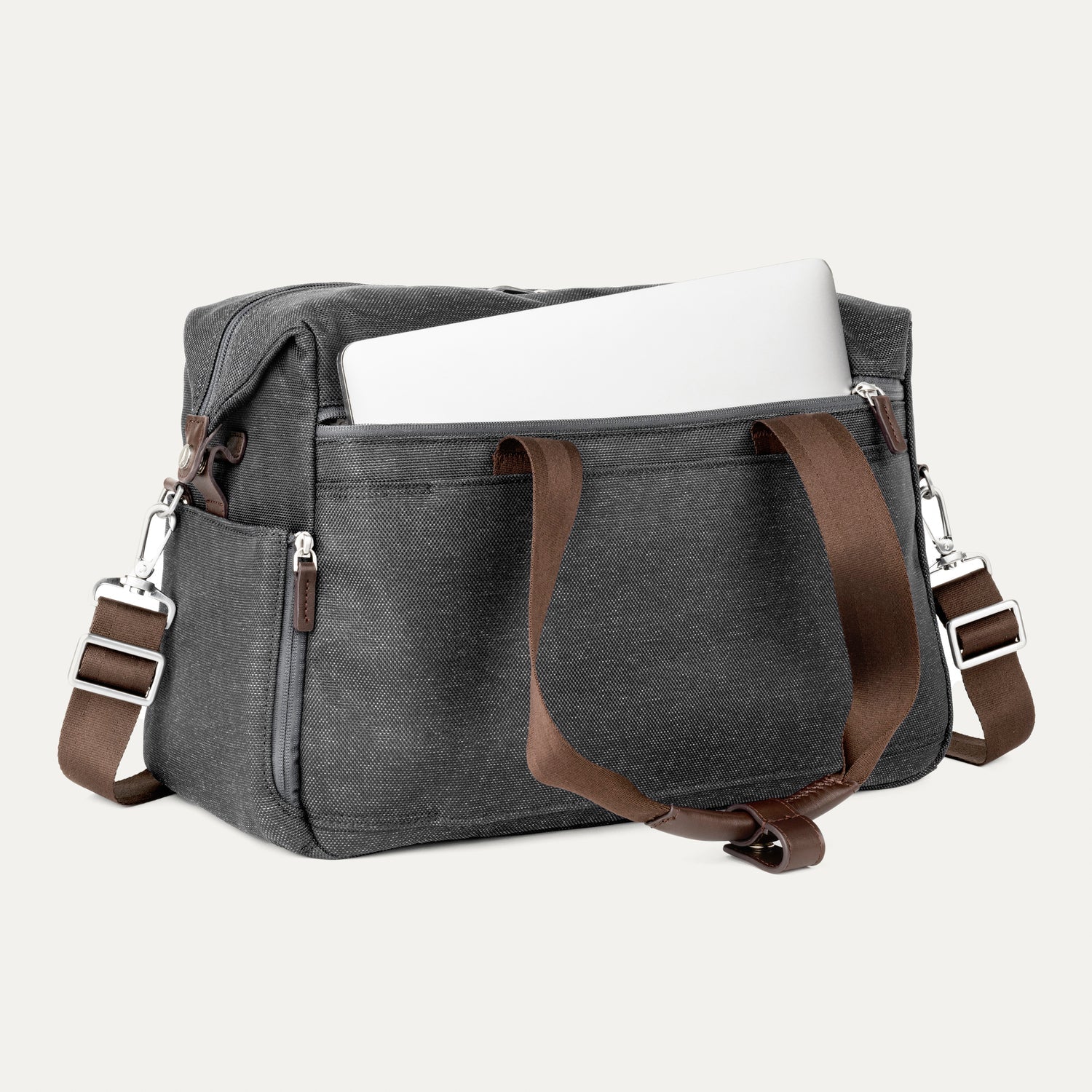 Vintage grey tote with a laptop in the padded sleeve compartment on a white background