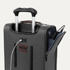 Close-up of grey suitcase with extended handle and visible USB charging cable, on white background