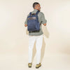 Person wearing a true navy slim backpack on a white background