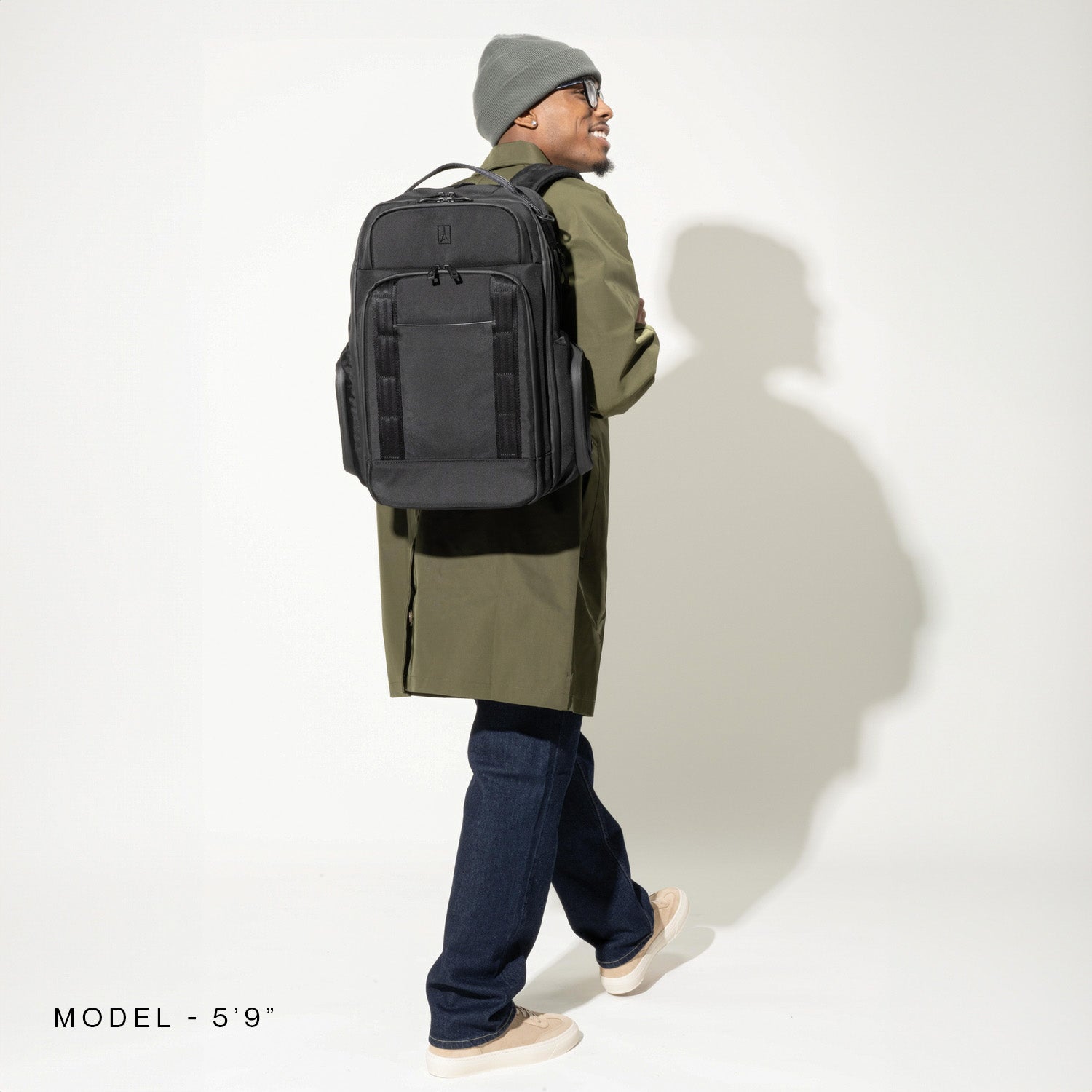 Person wearing a black backpack on a white background