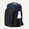 Side view of aviator navy backpack with a water bottle in the side compartment on a white background.