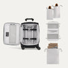 Open suitcase with travel accessories on a white background