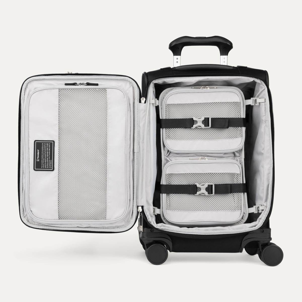 Black open suitcase with organizer strap down on a white background