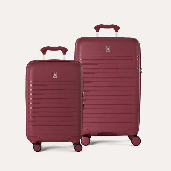 Two red suitcases of different sizes on a light gray background