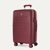 Maroon suitcase with a handle on a light gray background