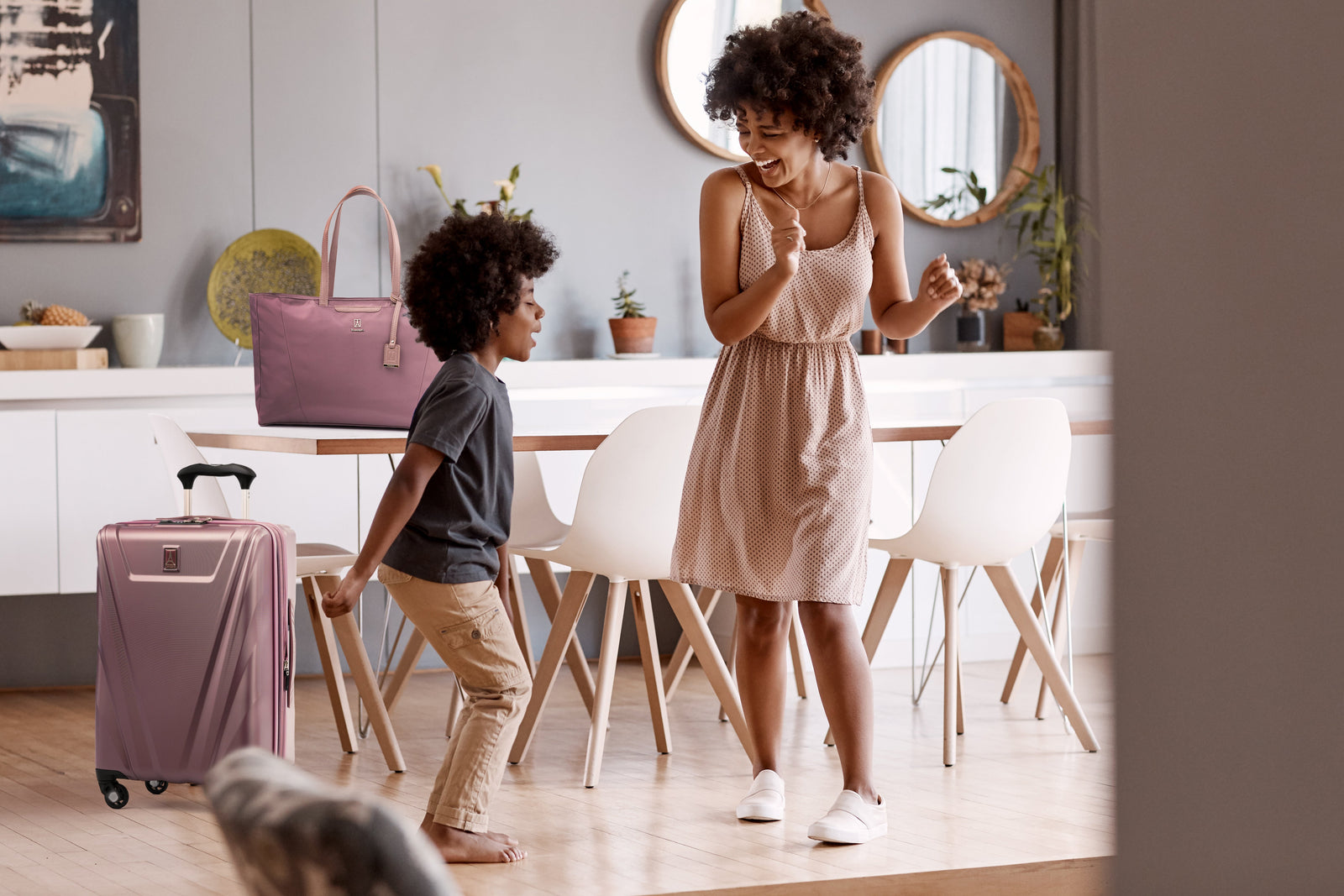 Mother and son dancing in a dining room
