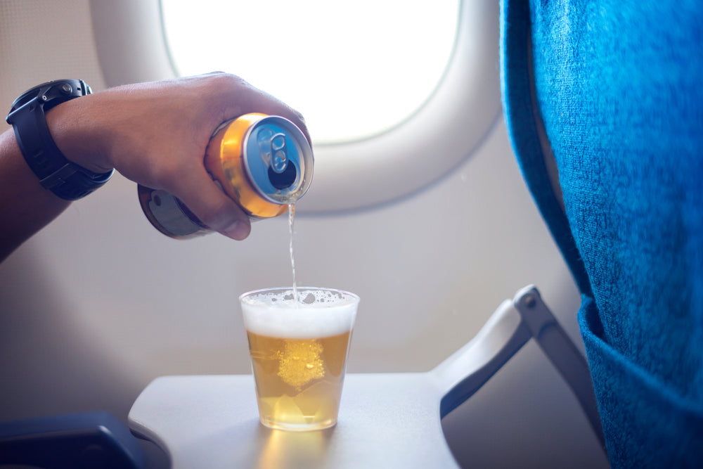 Man pouring alcohol on a plane