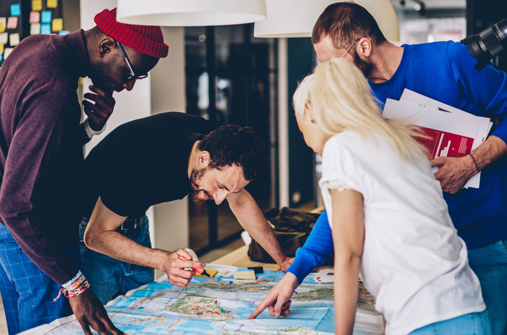 group of friends looking at a map
