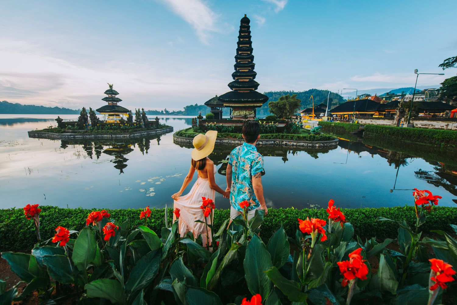 Couple holding handing looking at temple in Bali