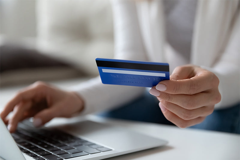 woman entering credit card information on a computer