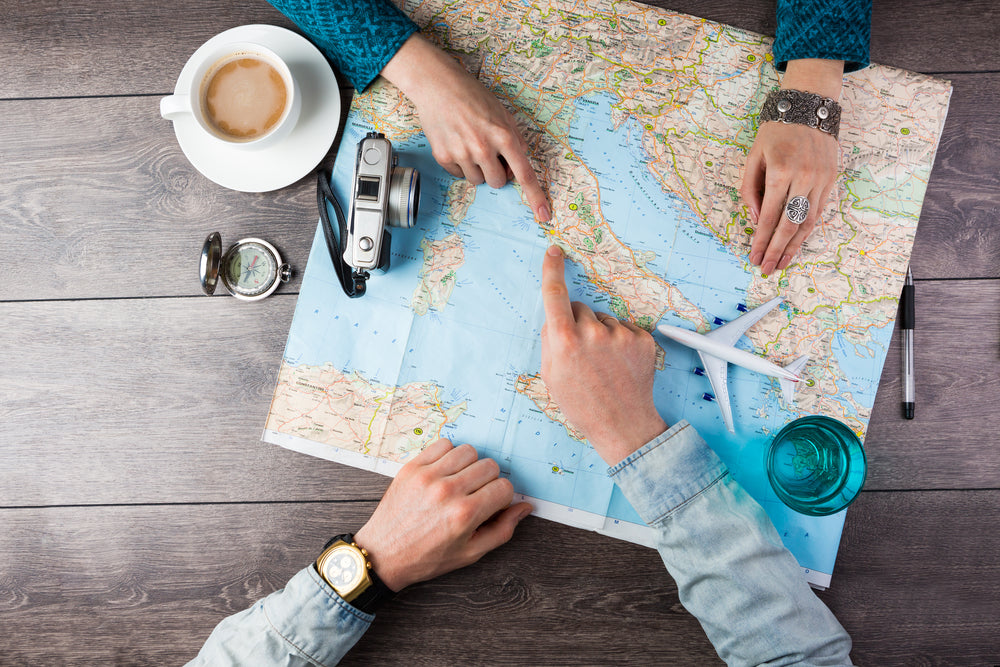 hands pointing at a map