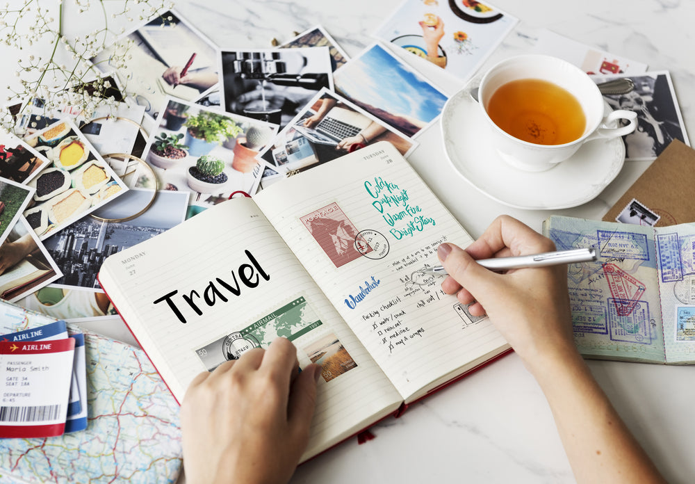 person looking through travel pictures and journaling