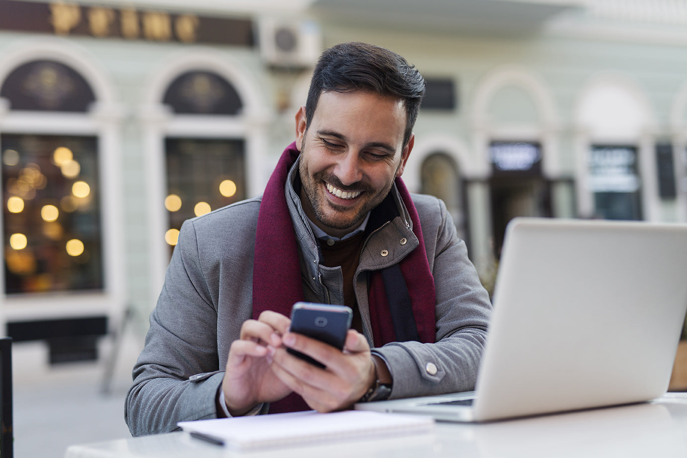 man looking at his phone and smiling