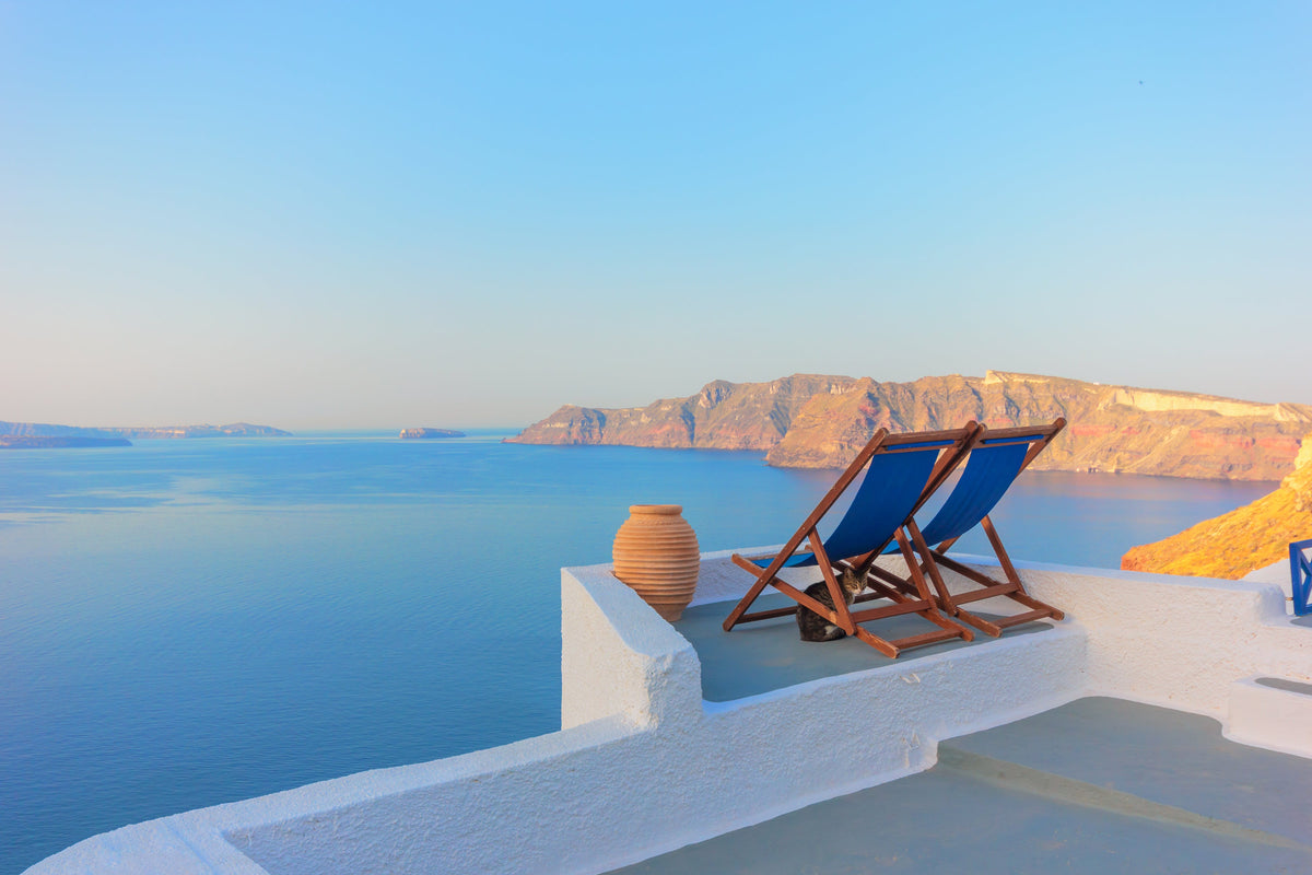 2 empty chairs overlooking the ocean