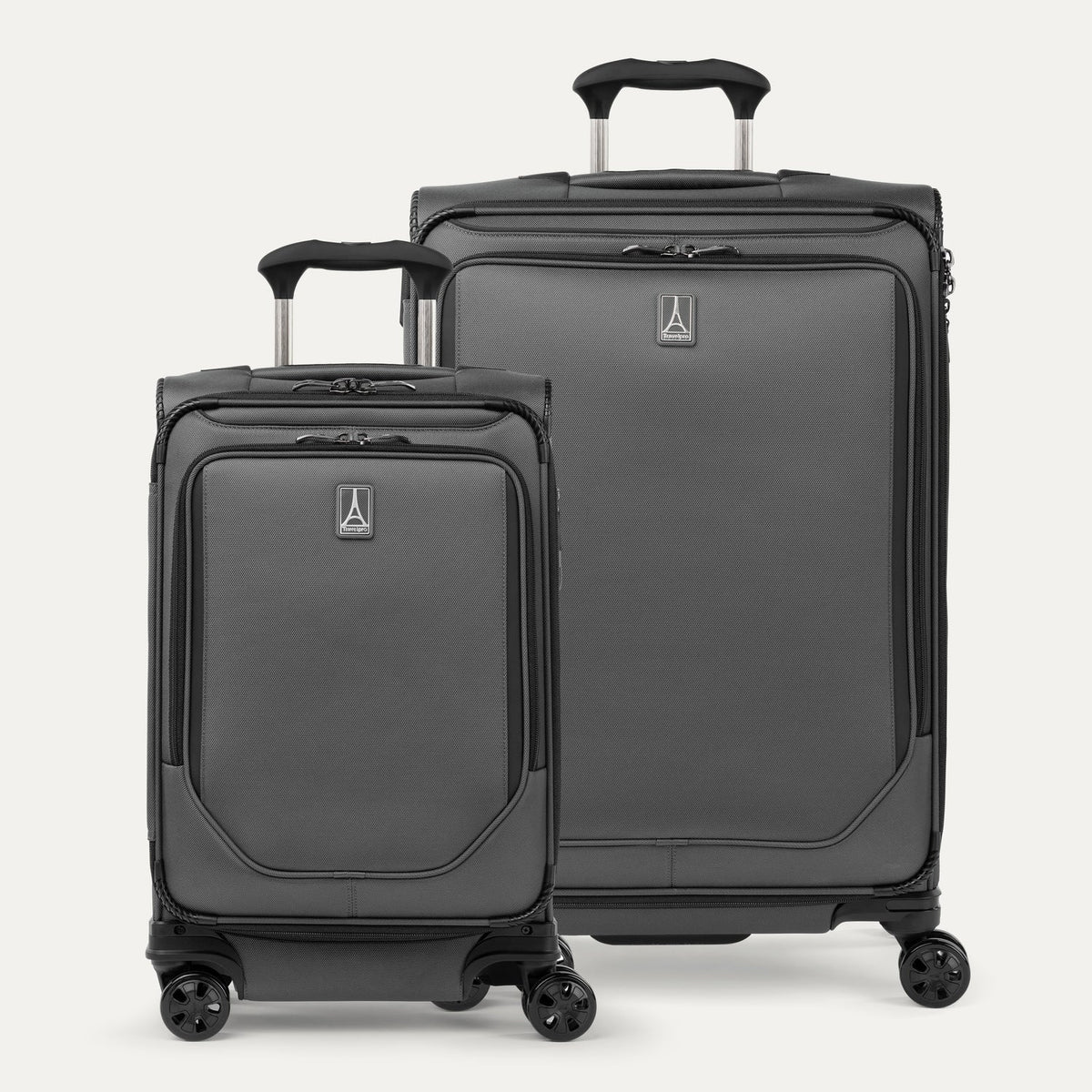 A set of two gray travel spinner suitcases, one carry-on size and one medium check-in size, with the travelpro logo visible on the front.