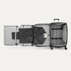 Open suitcase with suit displayed in fold out suiter compartment on white background