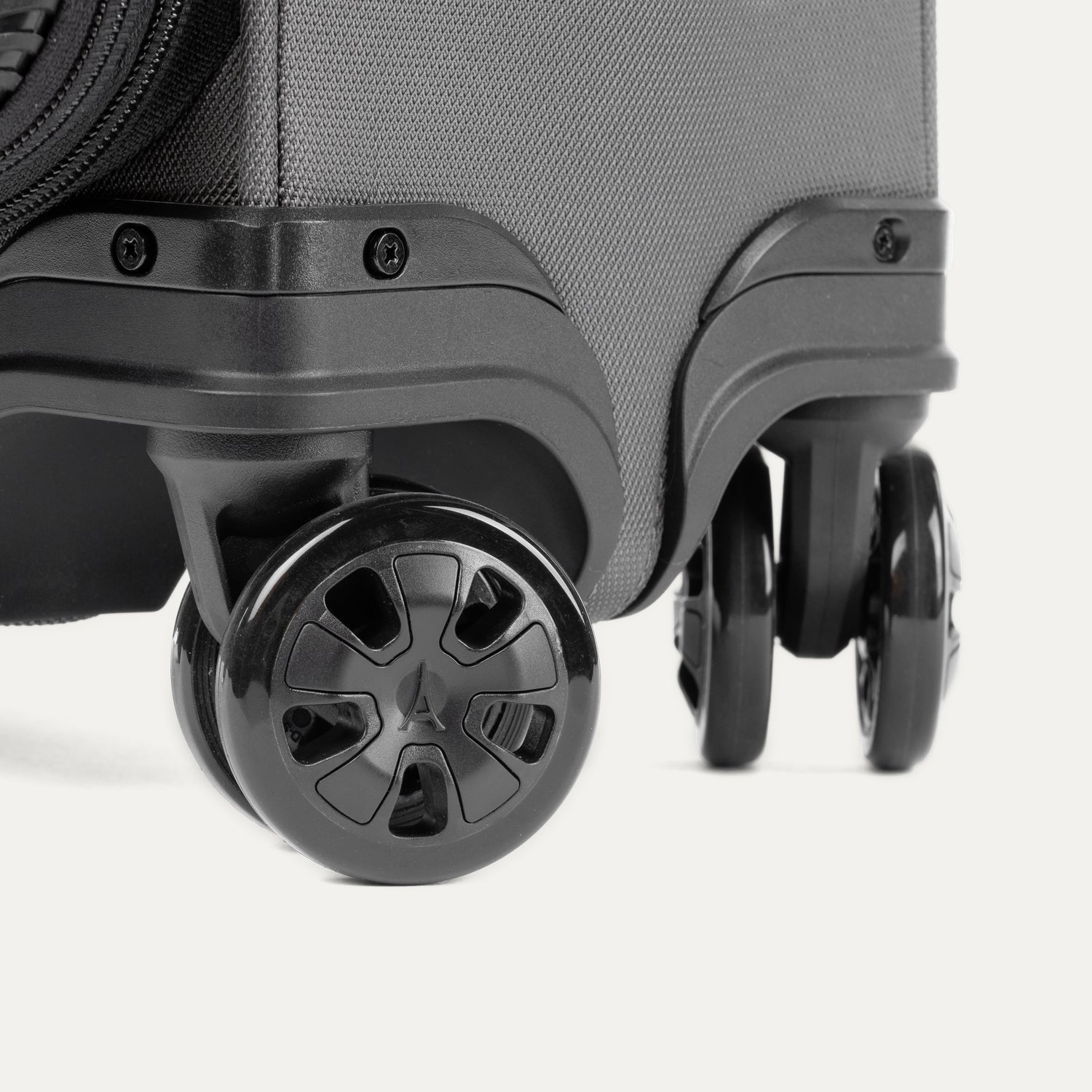 Close-up of suitcase wheels on a white background