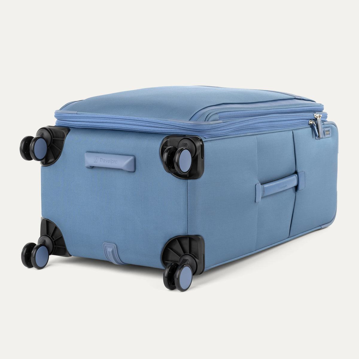 Bottom view of Travelpro Versapack Spinner in Elemental Blue, featuring color-matched 360° wheels