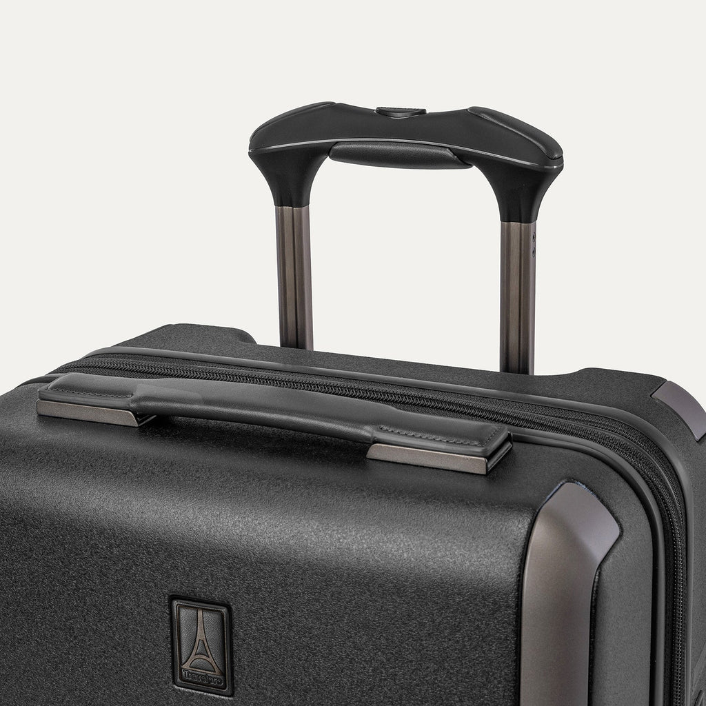 Close-up of the leather-wrapped top handle and PowerScope Lite extension handle on the Travelpro Platinum Reserve Compact Carry-On Hardside Spinner in Black Dust