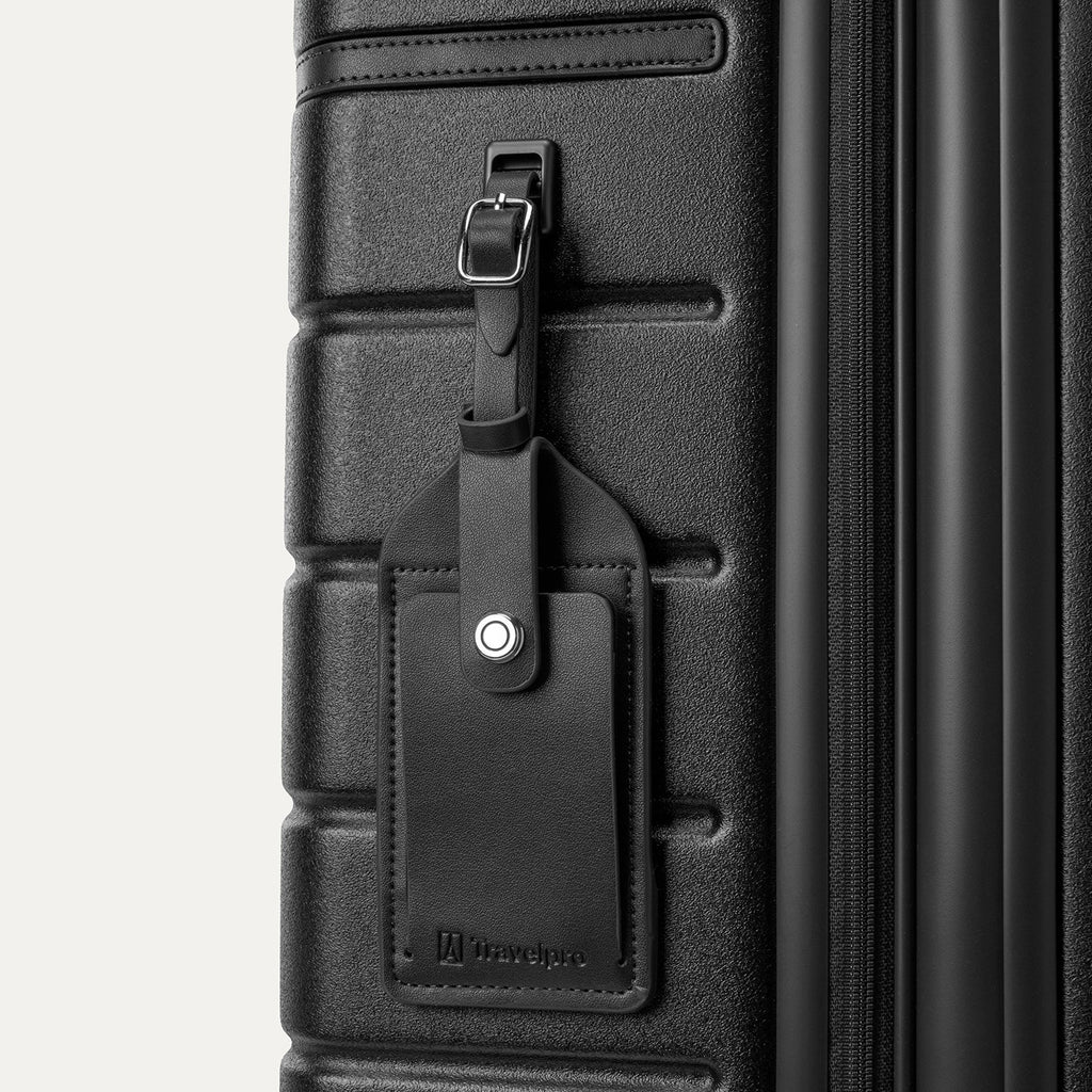 Close-up of the full-grain leather luggage tag on the Travelpro Platinum Reserve Compact Carry-On Hardside Spinner in Black Dust