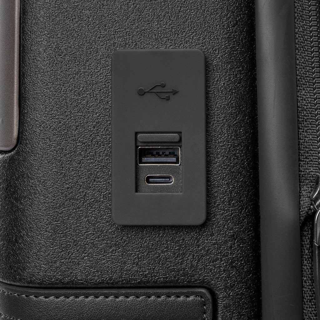 Close-up of the external USB-A and USB-C charging ports on the Travelpro Platinum Reserve Compact Carry-On Hardside Spinner in Black Dust