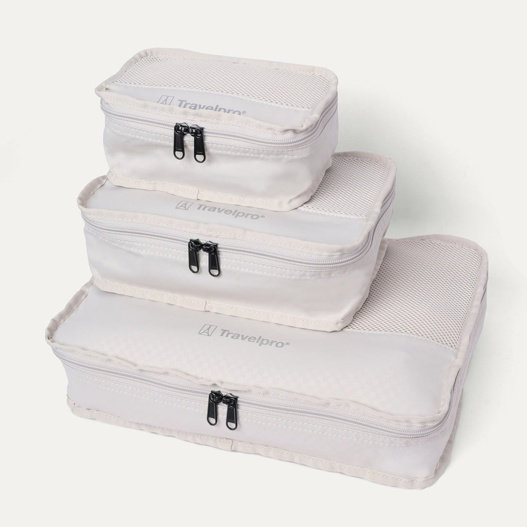 Packing cubes included with the Travelpro Platinum Reserve Compact Carry-On Hardside Spinner in Black Dust, stacked by size