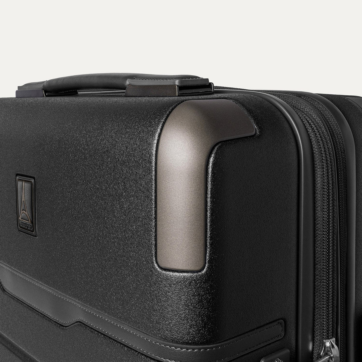 Close-up of the zinc corner armour on the Travelpro Platinum Reserve Compact Carry-On Hardside Spinner in Black Dust