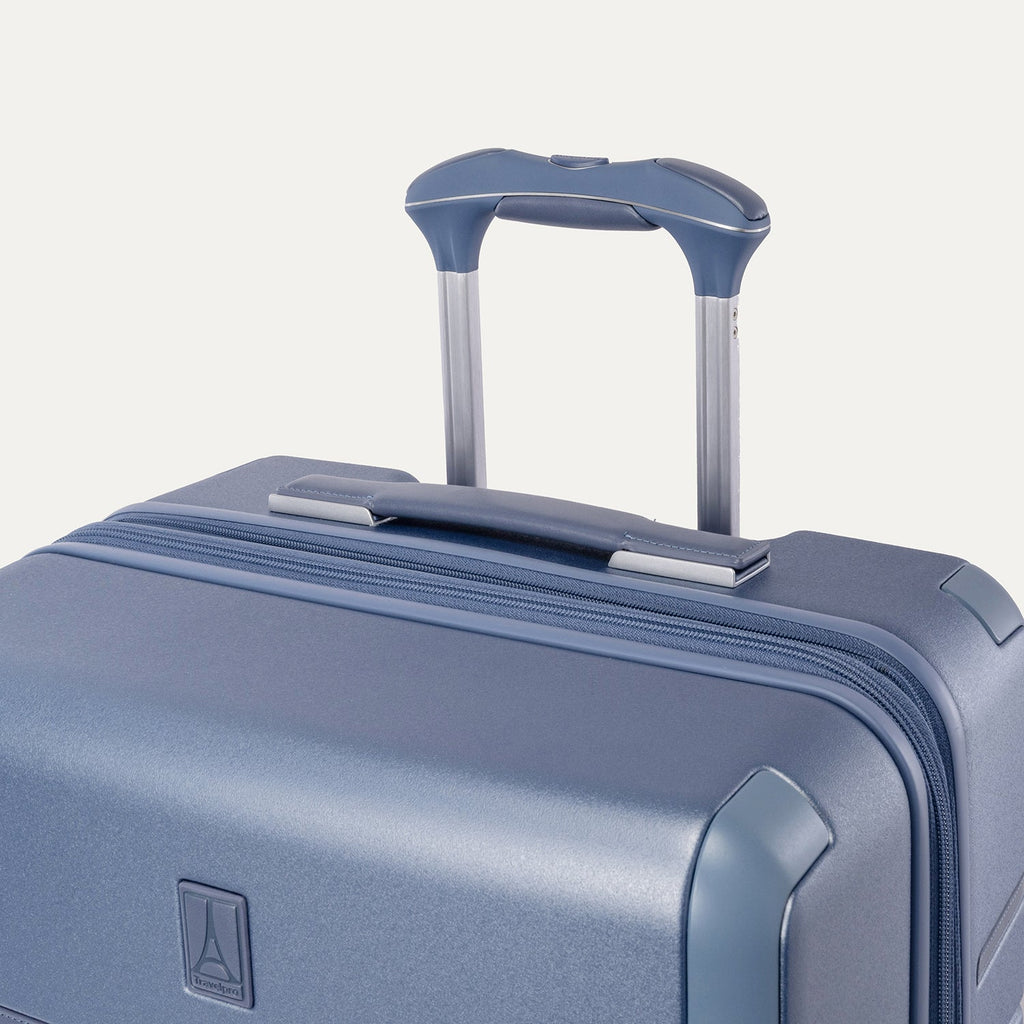 Close-up of the leather-wrapped top handle and PowerScope Lite extension handle on the Travelpro Platinum Reserve Compact Carry-On Hardside Spinner in Steel Blue