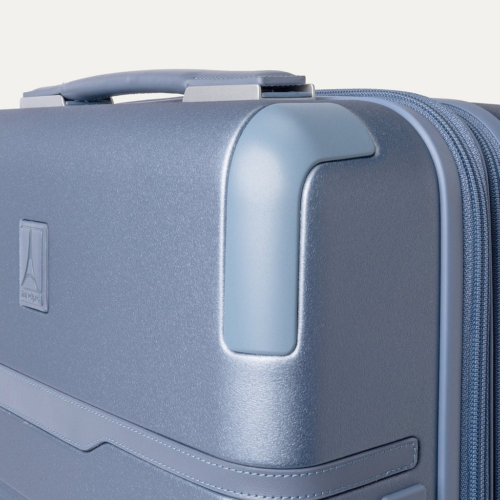 Close-up of the zinc corner armour on the Travelpro Platinum Reserve Compact Carry-On Hardside Spinner in Steel Blue