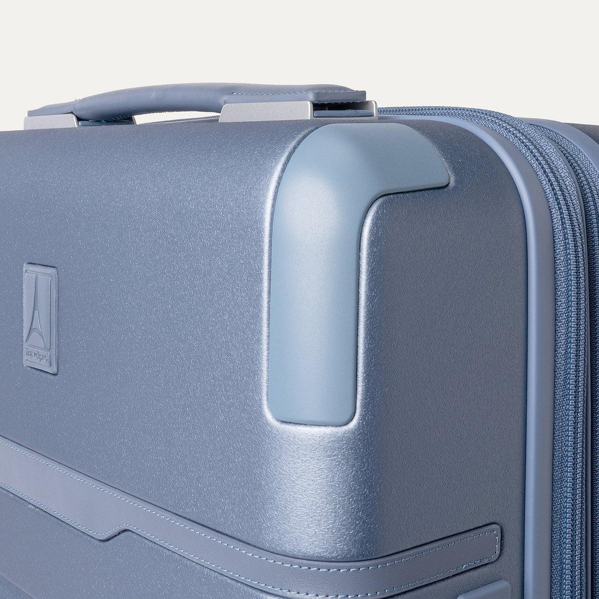 Close-up of the zinc corner armour on the Travelpro Platinum Reserve Compact Carry-On Hardside Spinner in Steel Blue
