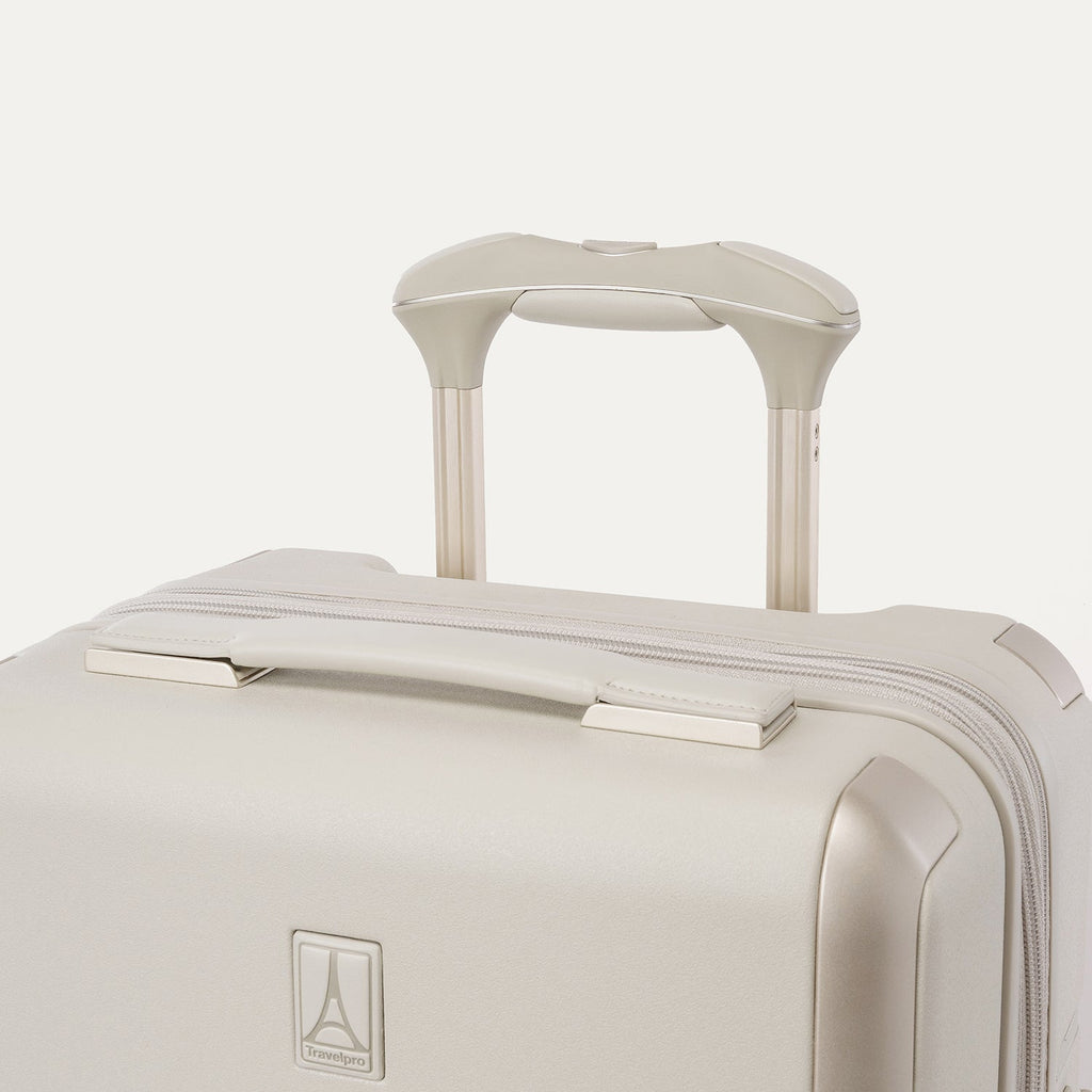 Close-up of the leather-wrapped top handle and PowerScope Lite extension handle on the Travelpro Platinum Reserve Compact Carry-On Hardside Spinner in Sandstone