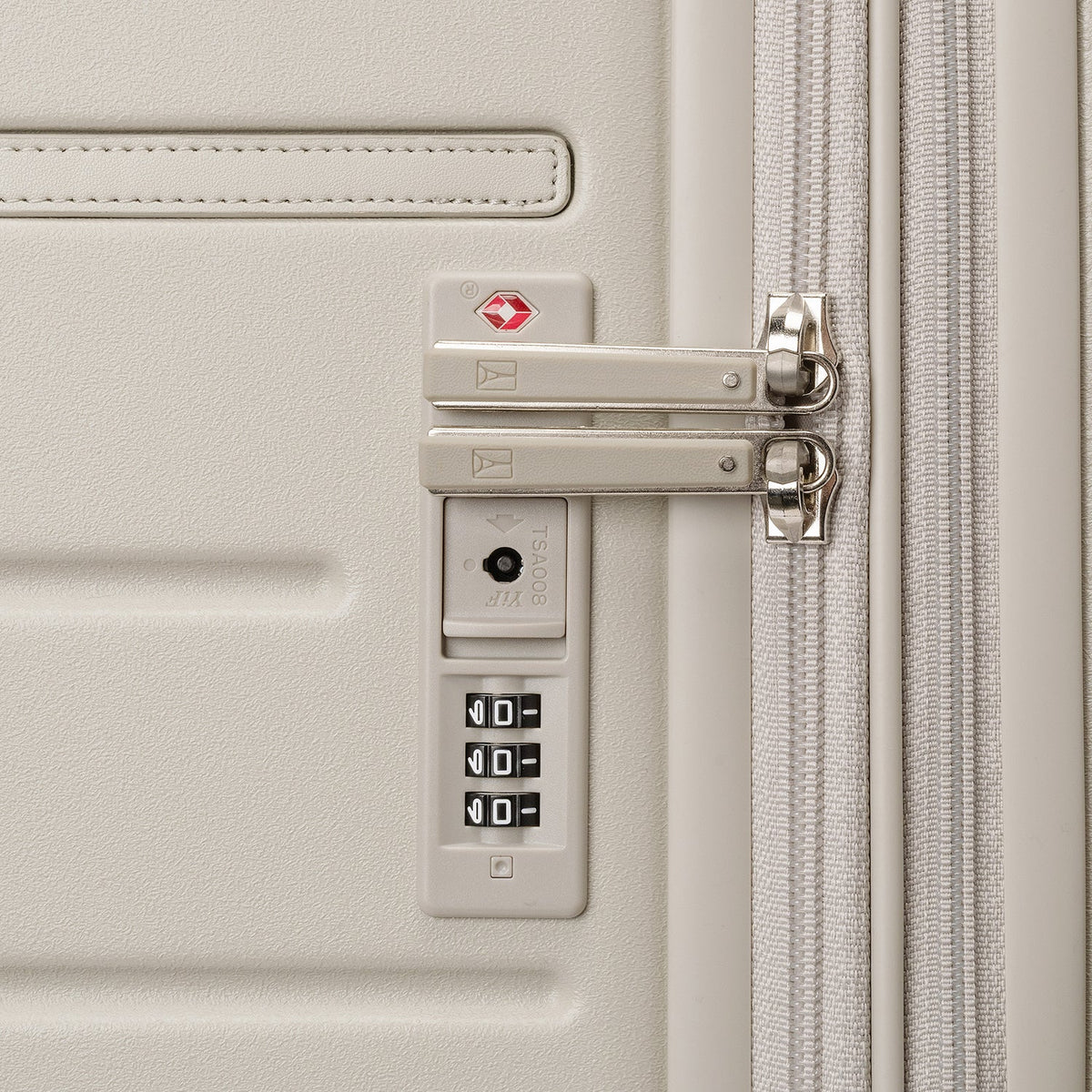 Close-up of the built-in TSA lock on the Travelpro Platinum Reserve Compact Carry-On Hardside Spinner in Sandstone