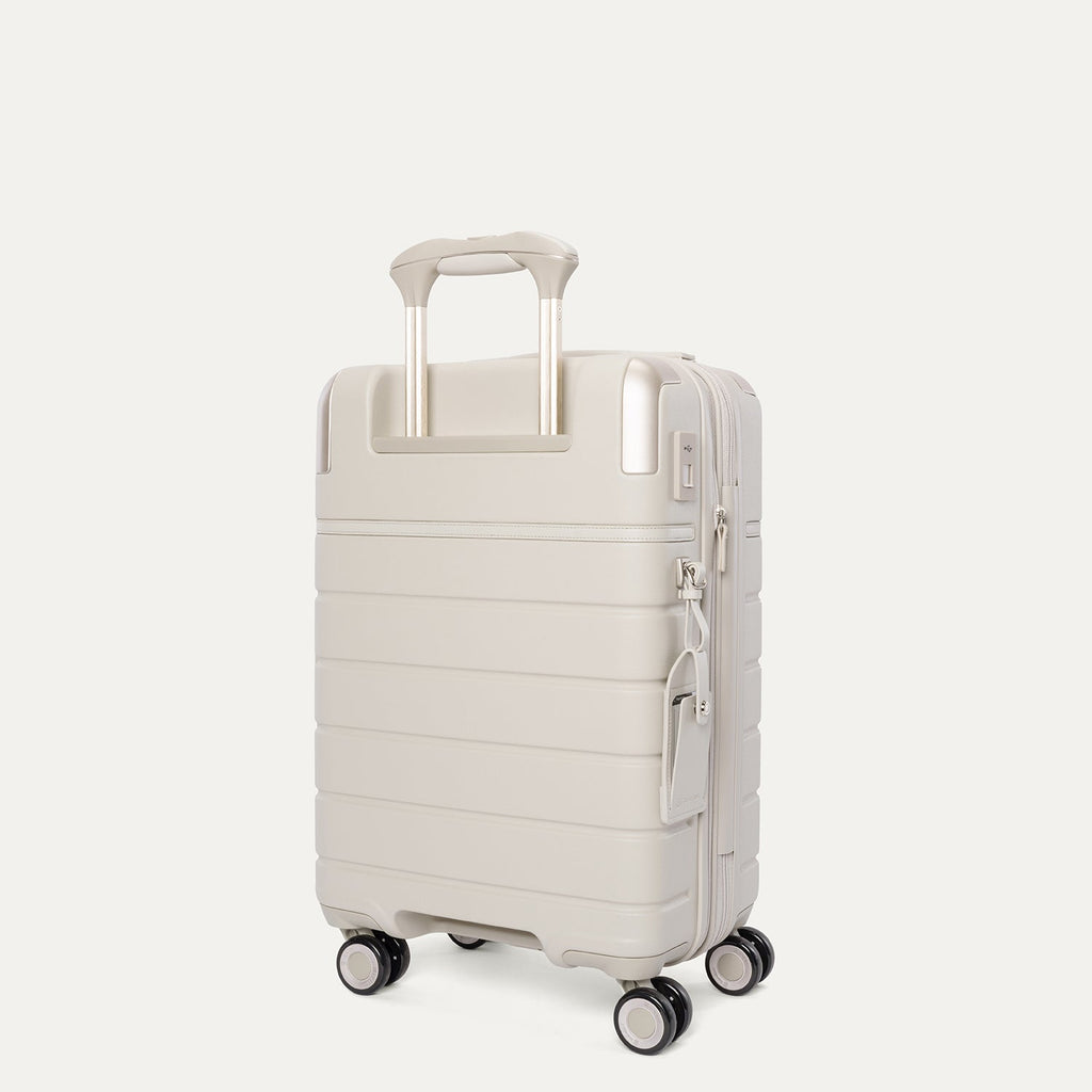 Rear angled view of the Travelpro Platinum Reserve Compact Carry-On Hardside Spinner in Sandstone