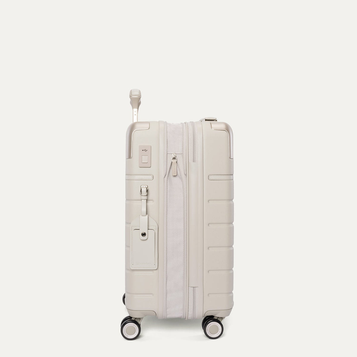 Side profile of the Travelpro Platinum Reserve Compact Carry-On Hardside Spinner in Sandstone, expanded for extra packing space