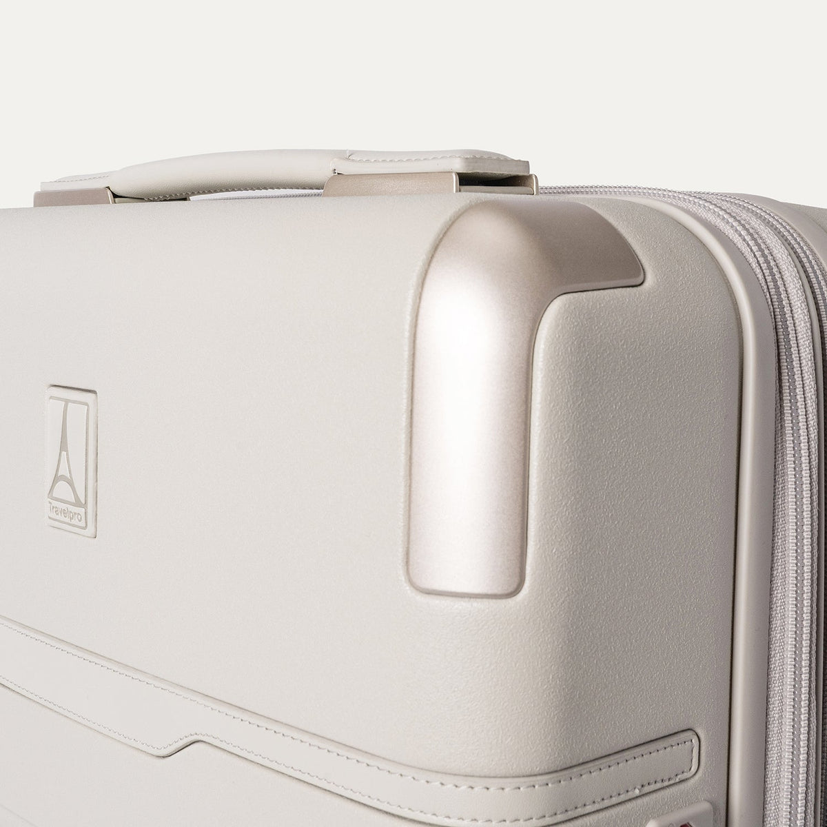 Close-up of the zinc corner armour on the Travelpro Platinum Reserve Compact Carry-On Hardside Spinner in Sandstone