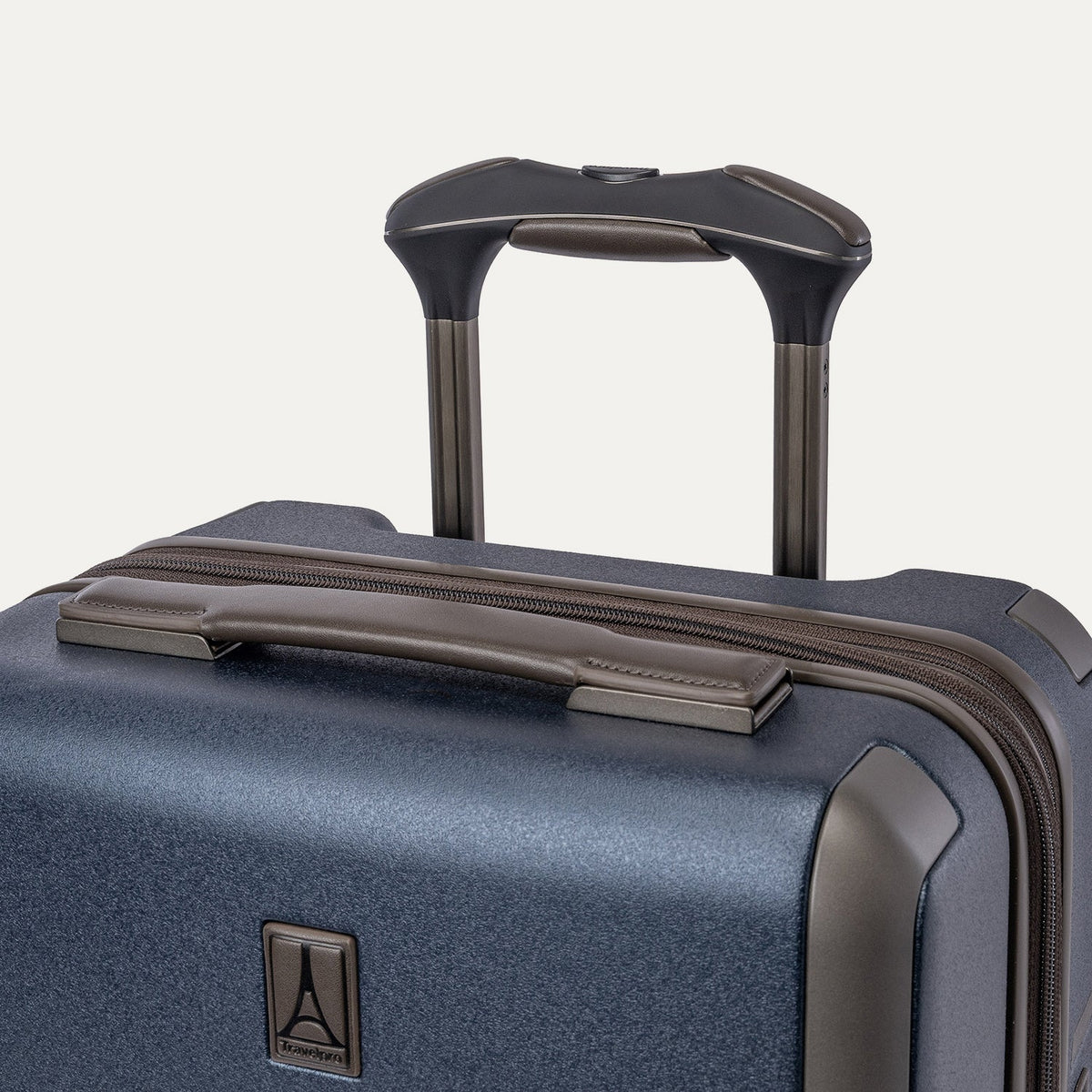 Close-up of the leather-wrapped top handle and PowerScope Lite extension handle on the Travelpro Platinum Reserve Compact Carry-On Hardside Spinner in Midnight Trail