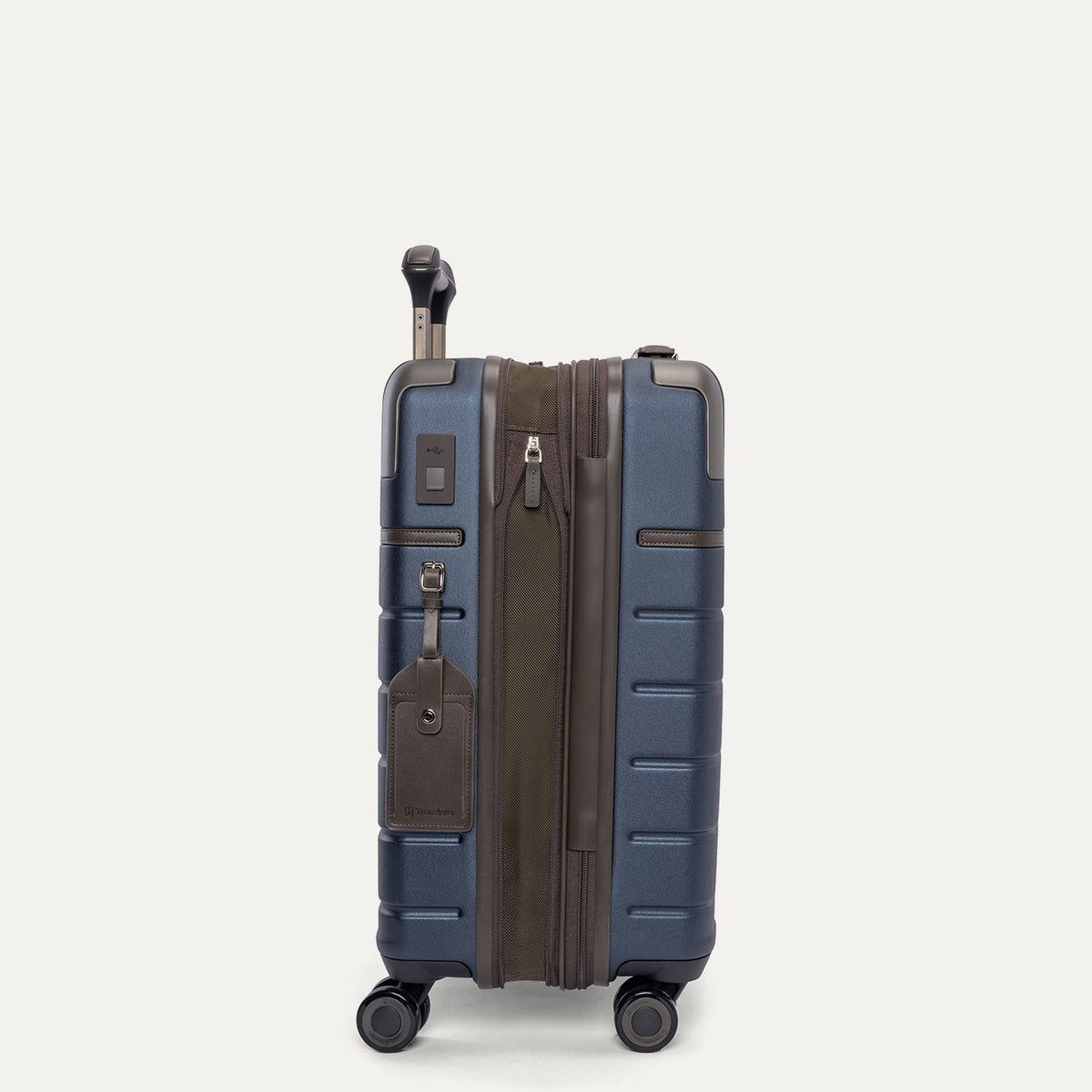 Side profile of the Travelpro Platinum Reserve Compact Carry-On Hardside Spinner in Midnight Trail, expanded for extra packing space
