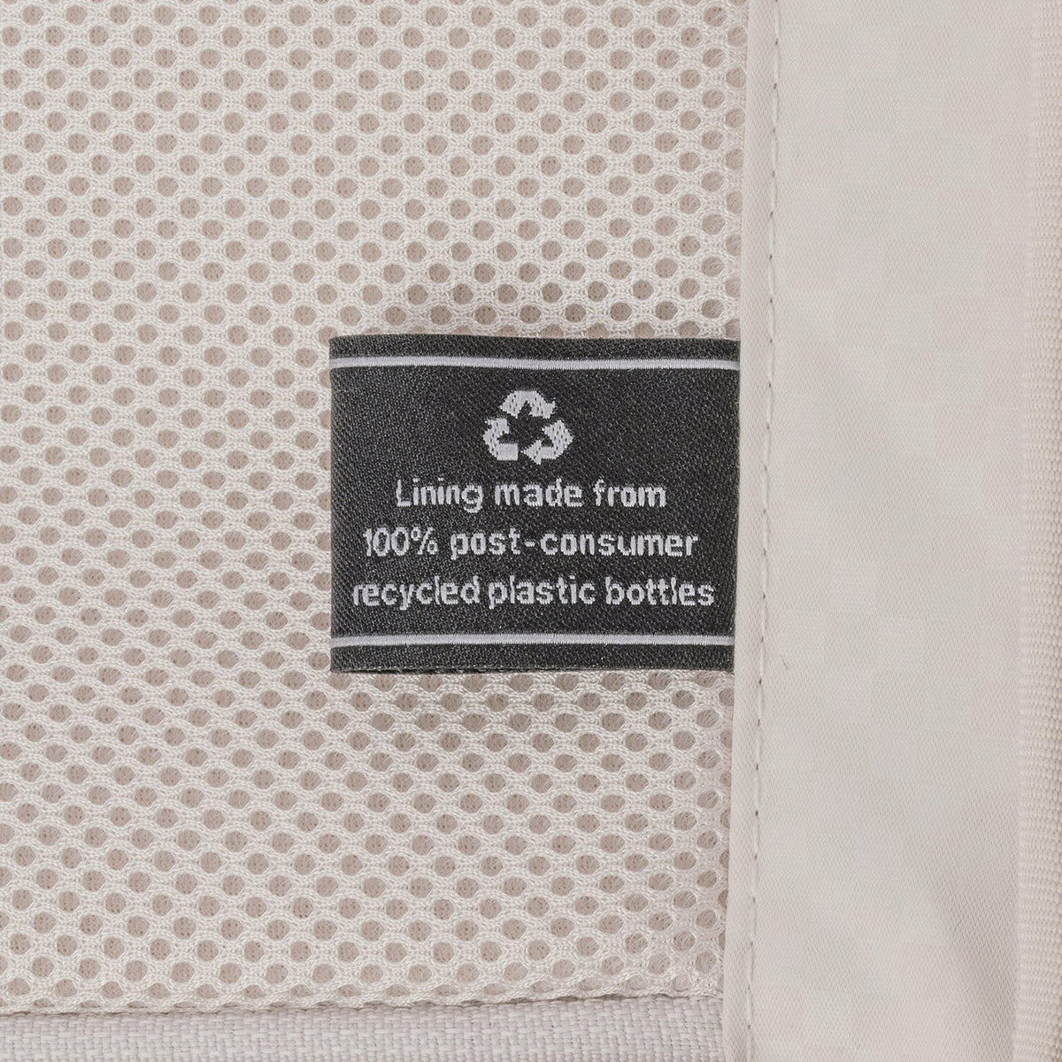 ECOFAB lining label inside the Travelpro Platinum Reserve Medium Check-In Hardside Spinner in Black Dust, made from 100% post-consumer recycled plastic bottles