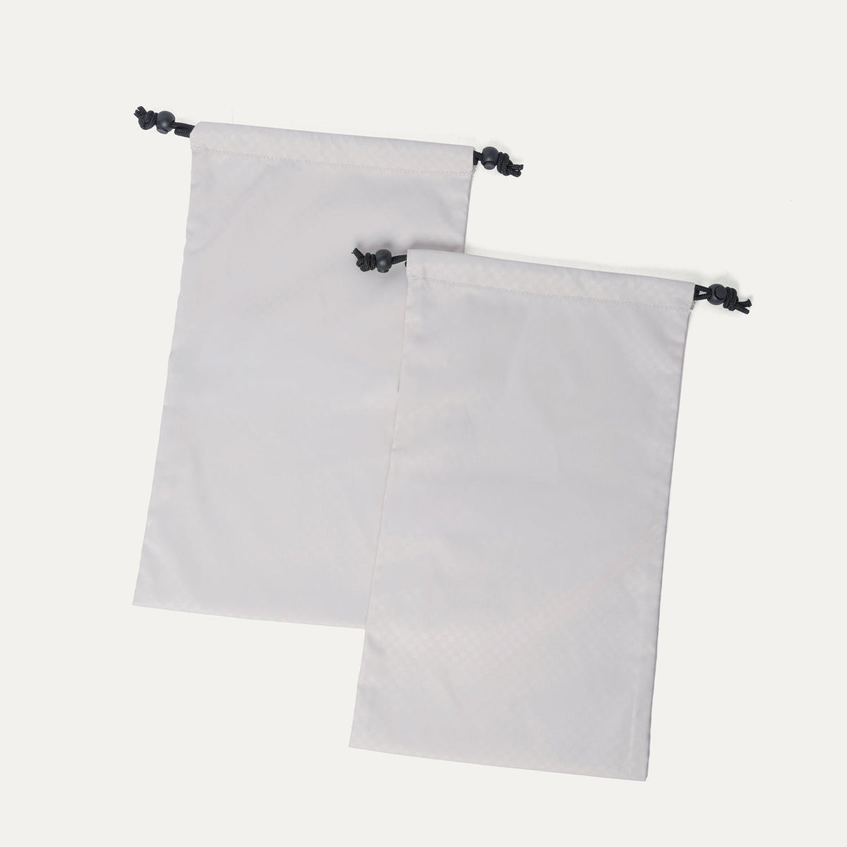 Removable drawstring shoe bags included with the Travelpro Platinum Reserve Medium Check-In Hardside Spinner in Black Dust