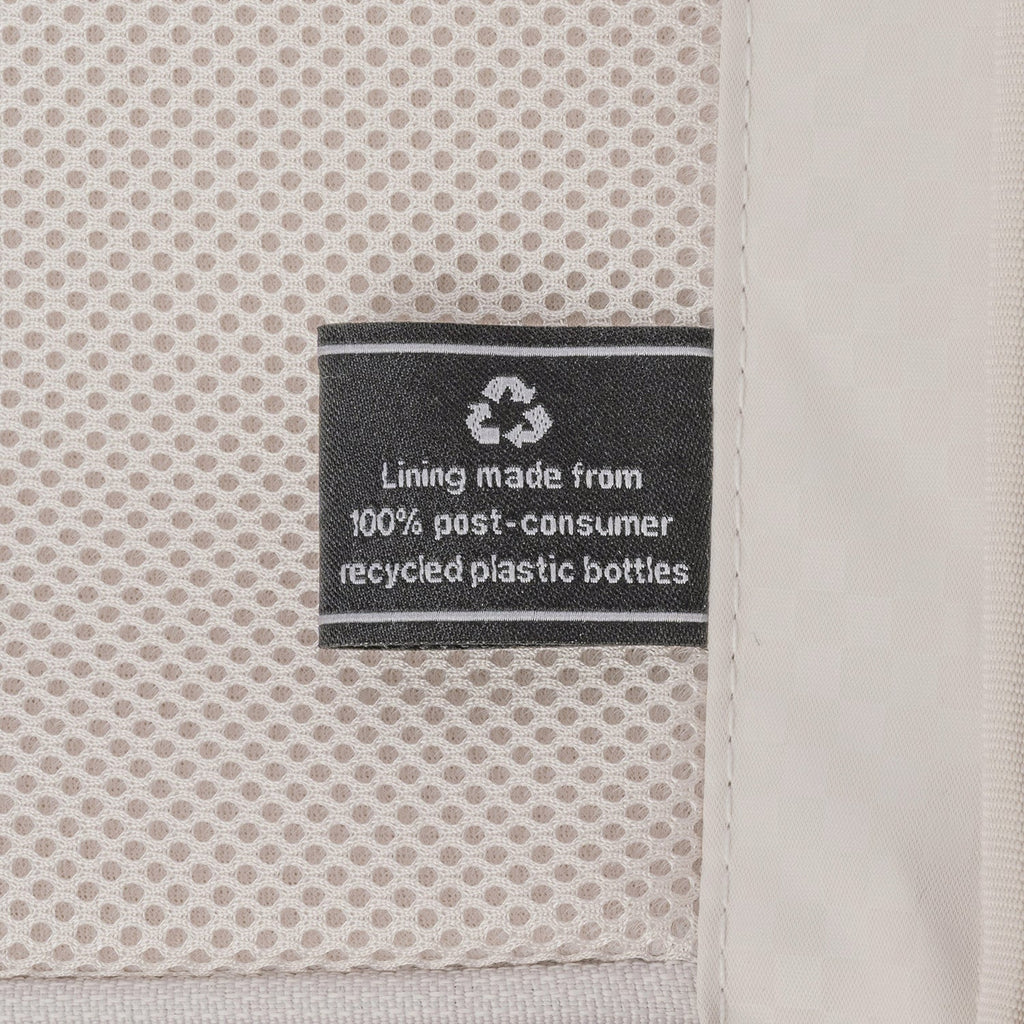 ECOFAB lining label inside the Travelpro Platinum Reserve Medium Check-In Hardside Spinner in Steel Blue, made from 100% post-consumer recycled plastic bottles