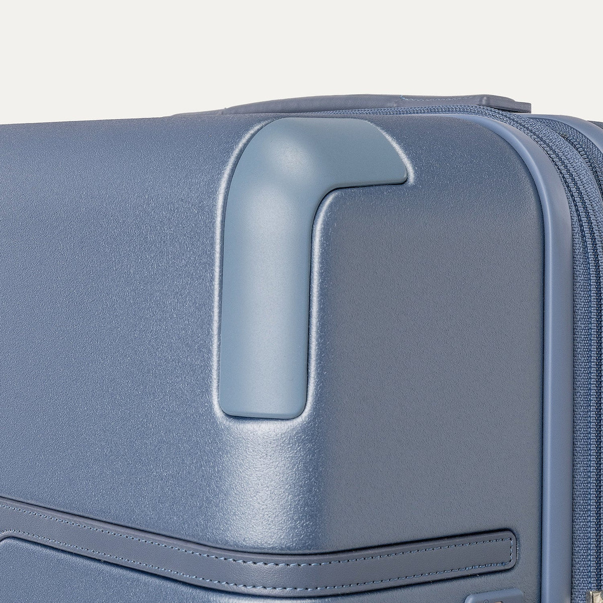 Close-up of the zinc corner armour on the Travelpro Platinum Reserve Medium Check-In Hardside Spinner in Steel Blue