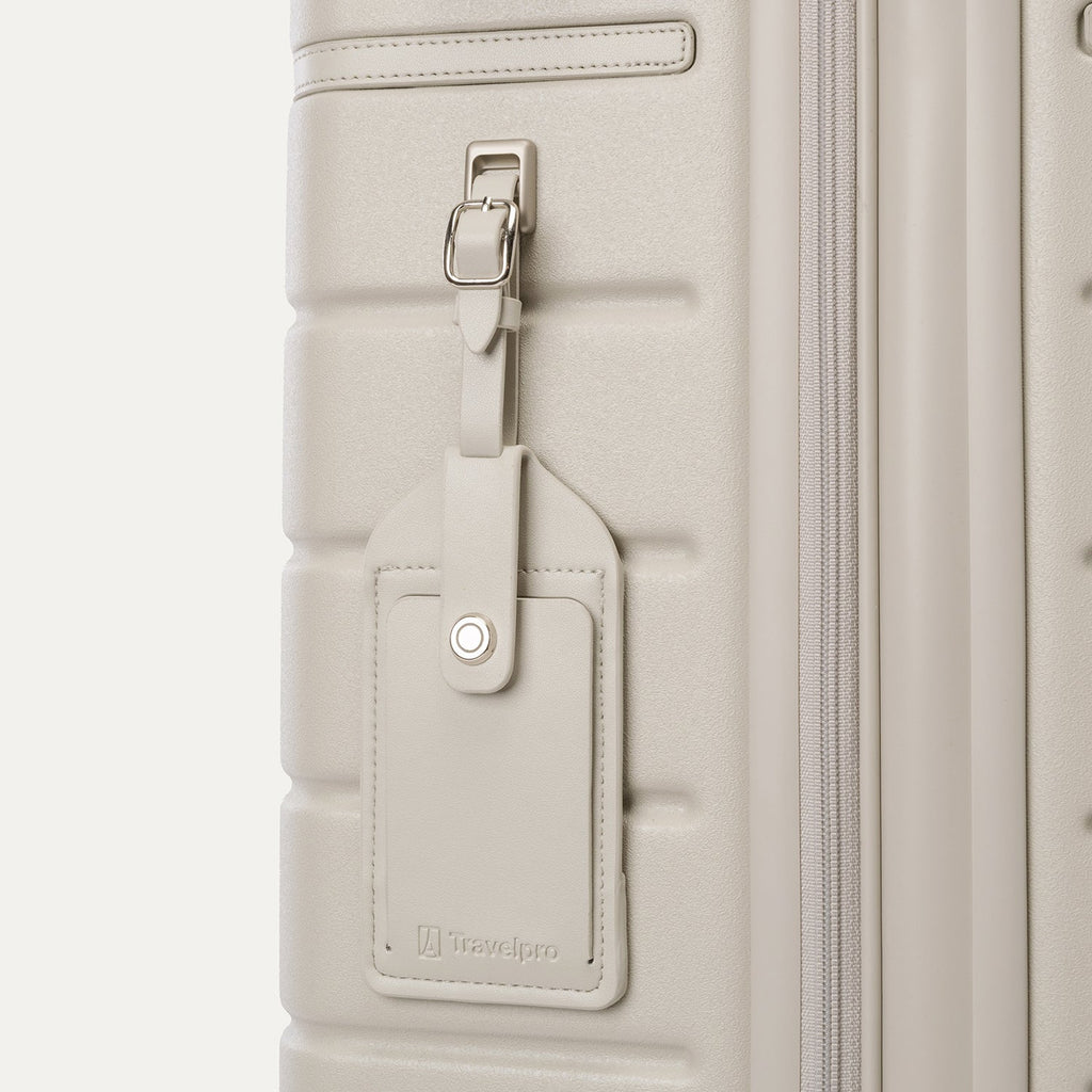 Close-up of the full-grain leather luggage tag on the Travelpro Platinum Reserve Medium Check-In Hardside Spinner in Sandstone