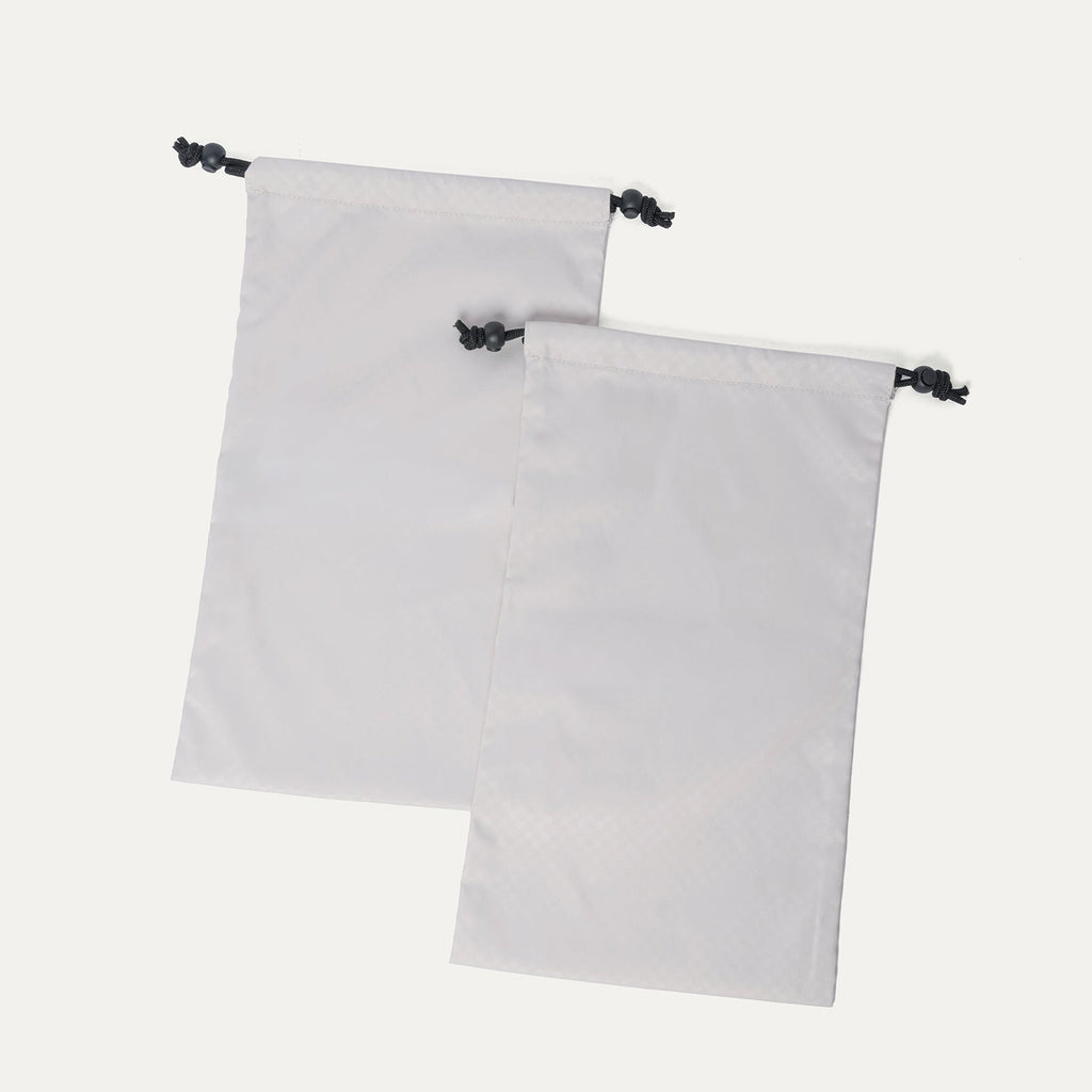 Removable drawstring shoe bags included with the Travelpro Platinum Reserve Medium Check-In Hardside Spinner in Sandstone