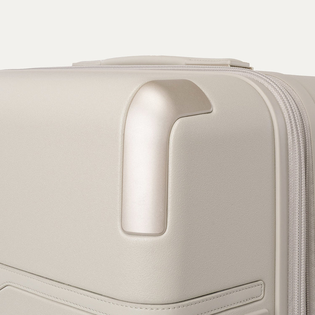 Close-up of the zinc corner armour on the Travelpro Platinum Reserve Medium Check-In Hardside Spinner in Sandstone